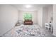 Bright, carpeted bedroom featuring a large window, a sofa, and play area at 15 White Spruce Ct, Durham, NC 27703
