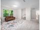 Bright, carpeted bedroom featuring a large window, a sofa, and play area at 15 White Spruce Ct, Durham, NC 27703