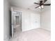 Carpeted bedroom features a ceiling fan, closet, and ensuite bathroom access at 15 White Spruce Ct, Durham, NC 27703