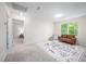 Spacious carpeted bedroom with a large window, a sofa, and a desk at 15 White Spruce Ct, Durham, NC 27703