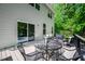 Spacious deck featuring outdoor seating, table and wooded backyard at 15 White Spruce Ct, Durham, NC 27703