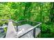 Elevated deck offers wooded views, stylish railings, and durable composite flooring at 15 White Spruce Ct, Durham, NC 27703