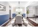 Stylish dining room with modern pendant lighting, dark hardwood floors and a view into the kitchen at 15 White Spruce Ct, Durham, NC 27703