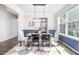 Elegant dining room featuring modern lighting fixture, hardwood floors, and blue and white accent wall at 15 White Spruce Ct, Durham, NC 27703