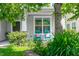 Inviting front porch with blue rocking chairs, stone accents, and lush landscaping at 15 White Spruce Ct, Durham, NC 27703
