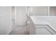 Hallway featuring neutral walls, carpeting, and doorways to various areas at 15 White Spruce Ct, Durham, NC 27703