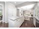 Modern kitchen island with granite countertops and white cabinets, open to the dining area at 15 White Spruce Ct, Durham, NC 27703