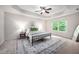 Bright bedroom with carpet, a modern ceiling fan, and a large window at 15 White Spruce Ct, Durham, NC 27703