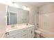 Well-lit bathroom with white cabinets, double vanity, and a tub/shower combo at 16 Decatur Dr, Fuquay Varina, NC 27526