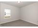New bedroom has carpet and view of backyard through window at 16 Decatur Dr, Fuquay Varina, NC 27526