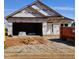 Unfinished new home featuring a two-car garage and white front door at 16 Decatur Dr, Fuquay Varina, NC 27526