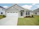Charming single-story home featuring a two-car garage and appealing stone and gray siding at 16 Decatur Dr, Fuquay Varina, NC 27526