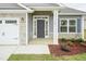 Charming exterior with stone accents, gray siding, and a covered front porch at 16 Decatur Dr, Fuquay Varina, NC 27526