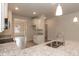 Well-lit kitchen with stainless steel appliances, grey wood floors, and easy access to other rooms at 16 Decatur Dr, Fuquay Varina, NC 27526