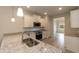 Bright kitchen features stainless steel appliances, granite countertops, and stylish pendant lighting at 16 Decatur Dr, Fuquay Varina, NC 27526