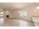 Bright living room featuring modern fireplace, window with a view and easy access to kitchen at 16 Decatur Dr, Fuquay Varina, NC 27526