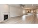 Spacious living room with open floorplan, fireplace, grey wood floors and easy access to kitchen at 16 Decatur Dr, Fuquay Varina, NC 27526