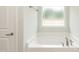 Bright and clean main bathroom features a soaking tub and a bright window at 16 Decatur Dr, Fuquay Varina, NC 27526