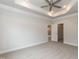 Spacious main bedroom with carpet, tray ceilings, bright lighting, and closet access at 16 Decatur Dr, Fuquay Varina, NC 27526