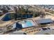This aerial view highlights the community pool, playground, and clubhouse, along with a pond in the surrounding neighborhood at 1820 Grassy Falls Ln, Wendell, NC 27591