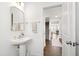 Neat bathroom with a pedestal sink, decor, and entry to hallway at 1820 Grassy Falls Ln, Wendell, NC 27591