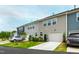 New townhomes feature colorful exteriors, manicured lawns, attached garages, and private driveways at 1820 Grassy Falls Ln, Wendell, NC 27591