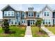 Inviting townhouse showcases manicured lawn, stone steps, and colorful flowers in a vibrant residential community at 1820 Grassy Falls Ln, Wendell, NC 27591