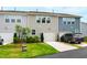 Well-maintained townhome exterior showing garages, green lawns, and tidy landscaping at 1820 Grassy Falls Ln, Wendell, NC 27591