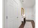 Hallway with wood floors, natural light, and interior doors at 1820 Grassy Falls Ln, Wendell, NC 27591