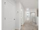 Hallway featuring white walls, neutral carpeting, and an abundance of natural light at 1820 Grassy Falls Ln, Wendell, NC 27591