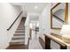 Bright hallway with staircase, leading to an open-concept living space at 1820 Grassy Falls Ln, Wendell, NC 27591