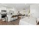 Inviting kitchen with island seating, stainless appliances and view into open living and dining areas of the home at 1820 Grassy Falls Ln, Wendell, NC 27591