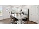 Modern kitchen featuring granite countertops, stainless steel appliances, a spacious island with barstools, and ample natural light at 1820 Grassy Falls Ln, Wendell, NC 27591