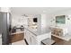 Open concept kitchen with granite island, modern appliances, and seamless flow into the dining and living areas at 1820 Grassy Falls Ln, Wendell, NC 27591