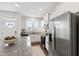 Bright kitchen features white cabinets, stainless steel appliances, and a granite island for modern functionality at 1820 Grassy Falls Ln, Wendell, NC 27591
