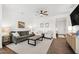 Inviting living room with modern ceiling fan, decor, and neutral color palette at 1820 Grassy Falls Ln, Wendell, NC 27591