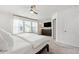 Main bedroom featuring a ceiling fan, many windows, and a television on the wall at 1820 Grassy Falls Ln, Wendell, NC 27591