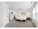Spacious main bedroom featuring a bench, lamps, ceiling fan, and an ensuite bathroom at 1820 Grassy Falls Ln, Wendell, NC 27591