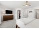 Main bedroom with a ceiling fan and a television mounted above a dresser at 1820 Grassy Falls Ln, Wendell, NC 27591