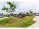 Playground with swings, climbing equipment, and a soft mulch surface; surrounded by green grass at 1820 Grassy Falls Ln, Wendell, NC 27591