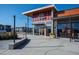 Modern restaurant exterior with large windows and outdoor seating, perfect for dining and social gatherings at 1820 Grassy Falls Ln, Wendell, NC 27591