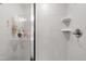 Updated bathroom shower featuring sleek, gray tile, glass doors, and modern fixtures at 1820 Grassy Falls Ln, Wendell, NC 27591
