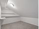 Finished attic space with carpet flooring and built-in shelving, providing extra storage at 197 Scranton Ct, Cameron, NC 28326