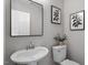 Bathroom featuring a pedestal sink, mirror, and decorative art at 197 Scranton Ct, Cameron, NC 28326