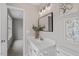 Bright bathroom featuring a white vanity with marble countertop and modern lighting fixture at 197 Scranton Ct, Cameron, NC 28326