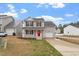 Charming two-story home with a well-manicured lawn and a bright red front door at 197 Scranton Ct, Cameron, NC 28326