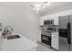 Bright kitchen with stainless steel appliances, white quartz counters, and light wood-look flooring at 197 Scranton Ct, Cameron, NC 28326