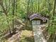 Aerial view of a home with a two car garage nestled in a wooded lot at 203 Wood Cir, Chapel Hill, NC 27514