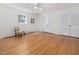 Bright bedroom features hardwood floors, white walls, ceiling fan, and natural light from a window at 203 Wood Cir, Chapel Hill, NC 27514