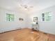 Bright bedroom with hardwood floors, radiator, multiple windows, and neutral walls for customization at 203 Wood Cir, Chapel Hill, NC 27514